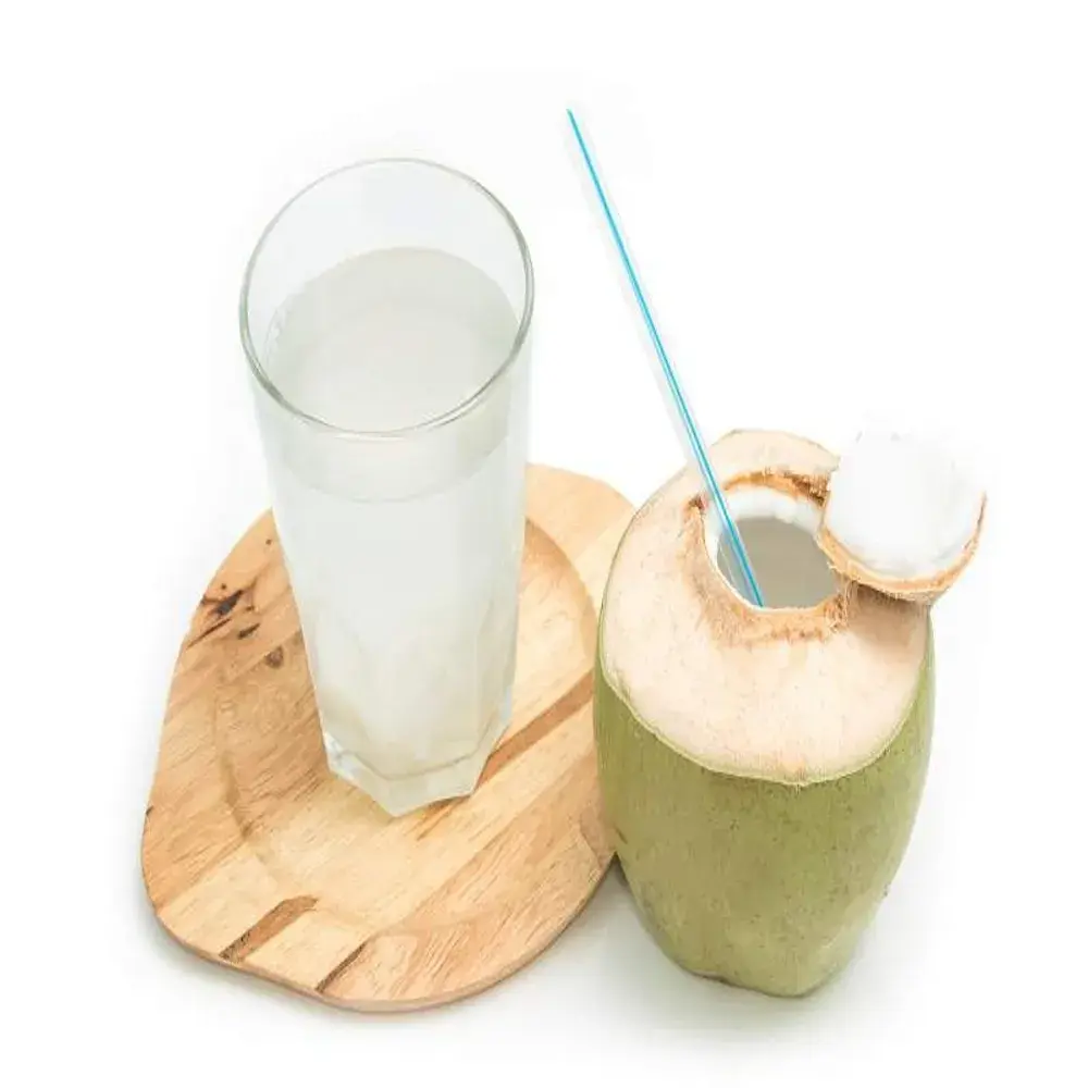 Fresh madafu (young coconut) with straw showing natural coconut water in Kenya